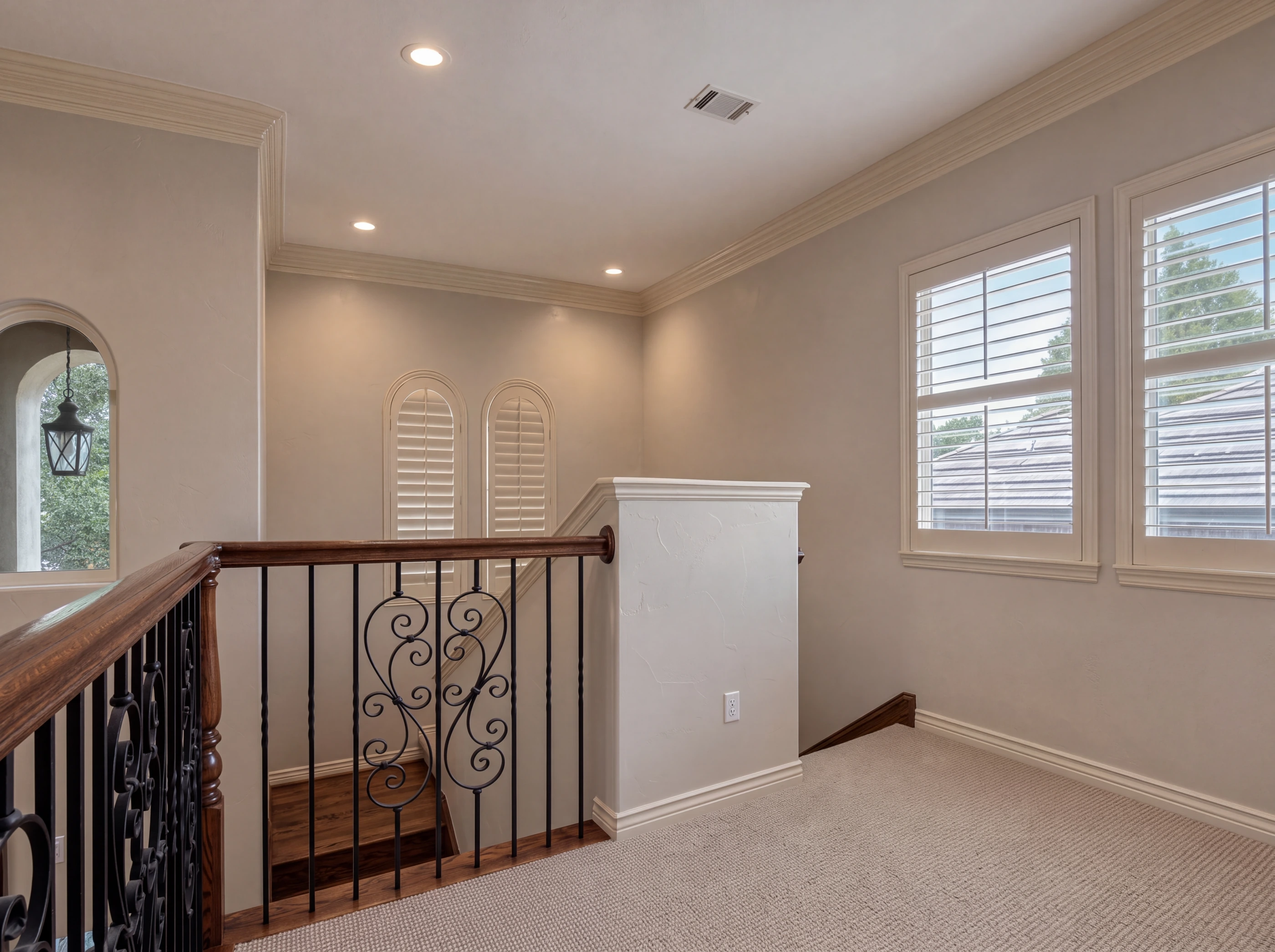 Upstairs landing with wrought-iron railing